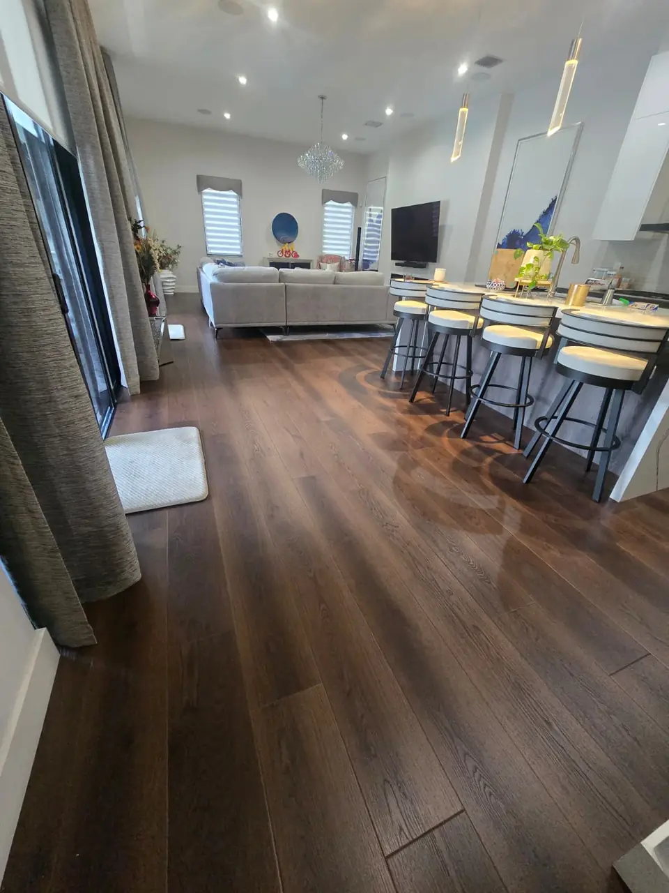 Open living room and kitchen with wide-plank brown oak luxury vinyl flooring