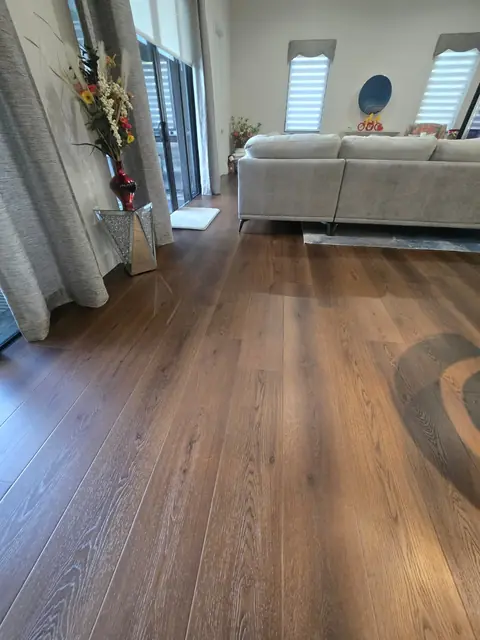 Wide-plank LVP with natural oak grain in a sunlit living room
