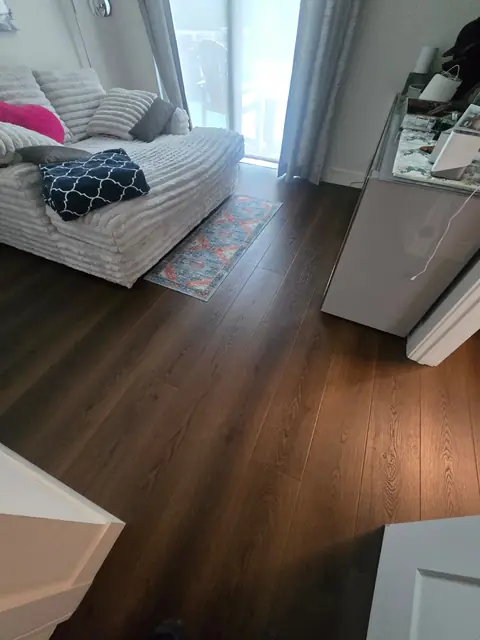Living room corner with brown oak luxury vinyl plank