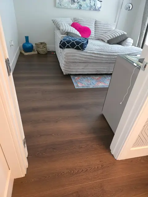Doorway with brown oak vinyl plank flowing into the living room