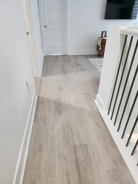 Upstairs hallway with LVP running past the stair railing