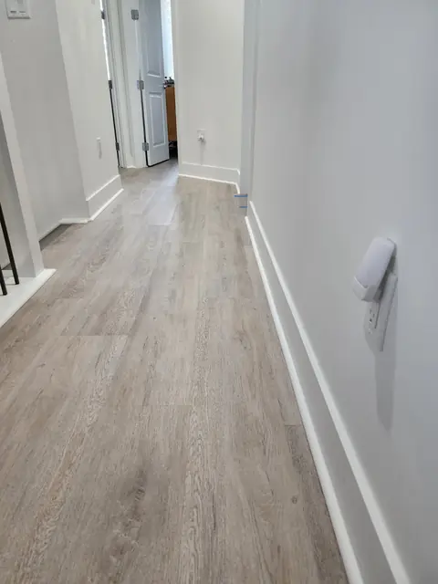 Hallway with light oak LVP and clean baseboard details
