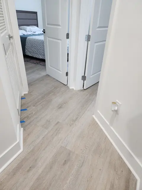 Bedroom doorway with luxury vinyl plank flowing between rooms