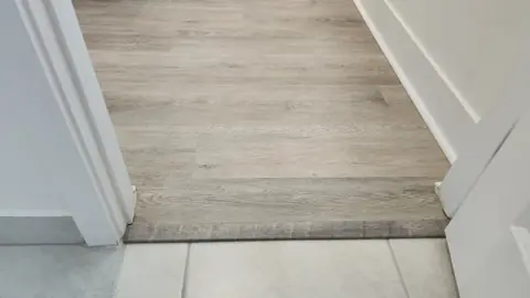 Flush transition from luxury vinyl plank to porcelain tile