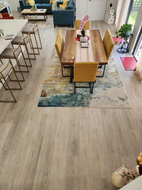 Dining table and chairs on light oak vinyl plank