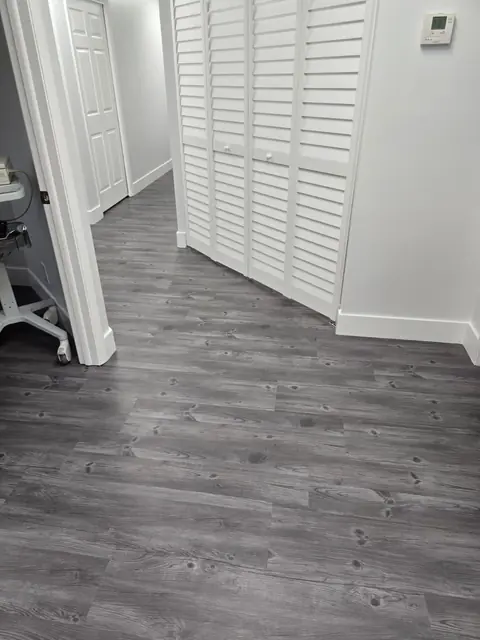Glue-down luxury vinyl flowing through office hallways and doorways