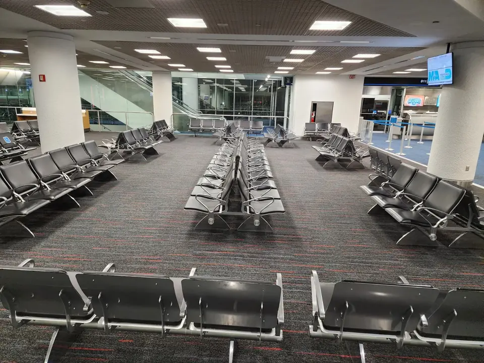 New carpet tile in a Miami International Airport gate lounge with rows of passenger seating