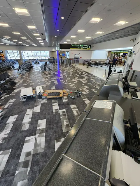 Removal of worn carpet tile in a busy airport gate area