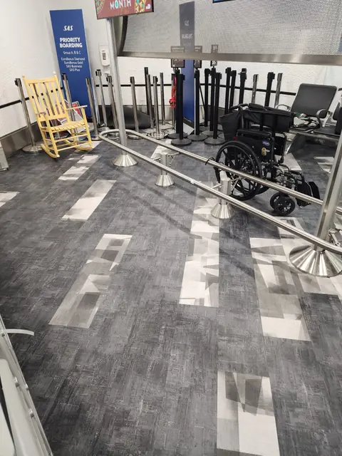 Partially removed carpet tile near accessible seating in the terminal