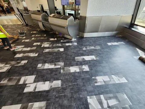 Flooring demolition in progress beside airline gate podiums