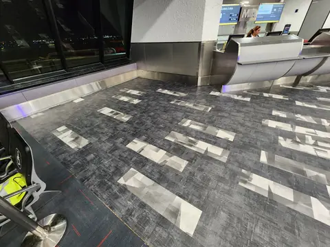 Old carpet tile removal along the terminal windows
