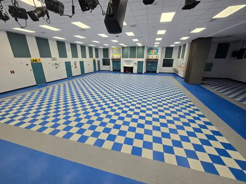 Durable VCT flooring across a school multipurpose room